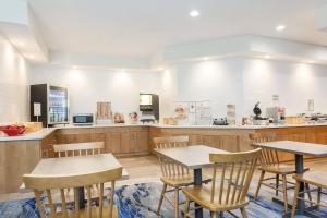 a restaurant with two tables and a counter at Fairfield Inn & Suites Houston Humble in Humble