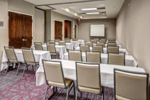 a conference room with tables and chairs and a screen at Courtyard Kansas City Country Club Plaza in Kansas City