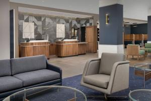 a lobby with two chairs and a waiting room at Courtyard by Marriott Indianapolis Plainfield in Plainfield