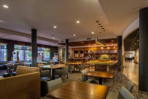 a restaurant with tables and chairs and a bar at Courtyard by Marriott New Braunfels River Village in New Braunfels
