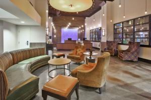 a waiting room with couches and tables and chairs at Fairfield Inn & Suites by Marriott Milwaukee Downtown in Milwaukee