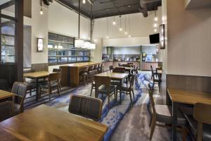 a restaurant with tables and chairs and a bar at Fairfield Inn & Suites by Marriott Milwaukee Downtown in Milwaukee