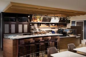 una cocina con barra con taburetes en Courtyard Winston-Salem University en Winston-Salem