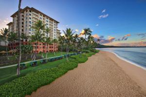 a view of a beach with palm trees and a building at Marriott's Maui Ocean Club - Lahaina & Napili Towers in Lahaina