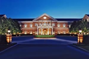 a large red brick building with a driveway at Westfields Marriott Washington Dulles in Chantilly