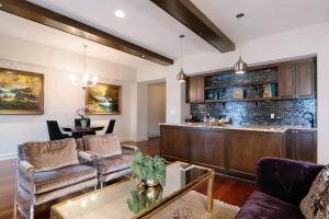 a living room with a couch and a bar at Grand Bohemian Hotel Mountain Brook, Autograph Collection in Birmingham