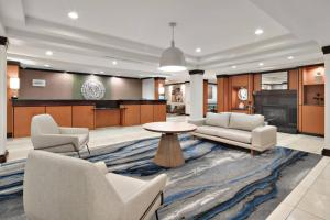 a living room with couches and a table and a kitchen at Fairfield Inn & Suites by Marriott Marietta in Marietta