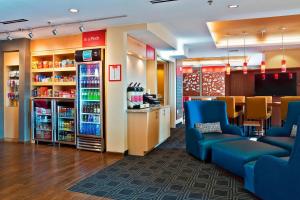 a grocery store with blue chairs and a counter at TownePlace Suites by Marriott Dodge City in Dodge City