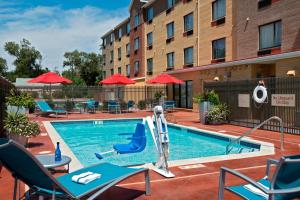 a pool at a hotel with chairs and a slide at TownePlace Suites by Marriott Dodge City in Dodge City