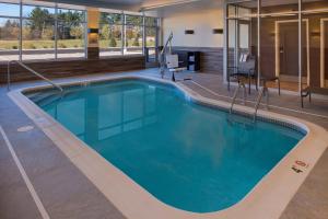 a swimming pool with blue water in a building at Fairfield Inn & Suites by Marriott Akron Stow in Stow