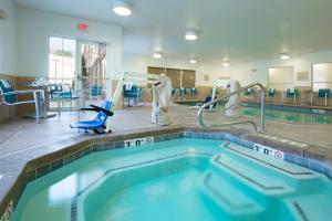 a swimming pool in a gym with an indoor swimming pool at TownePlace Suites Pocatello in Pocatello