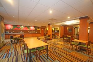 a dining area with tables and chairs in a cafeteria at Fairfield Inn & Suites by Marriott Aiken in Aiken