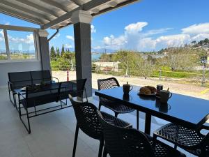 a table and chairs on a patio with a view at Nisos Family House in Perama