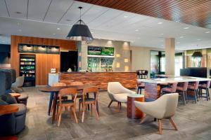 a restaurant with tables and chairs and a bar at Courtyard by Marriott LaGrange in La Grange
