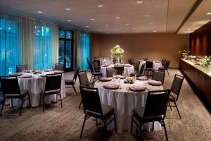 a banquet room with tables and chairs with white linens at Courtyard by Marriott LaGrange in La Grange