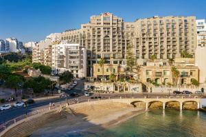 a view of a city with a bridge and buildings at Malta Marriott Resort & Spa in St. Julianʼs