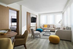 a living room with a couch and a table at Malta Marriott Resort & Spa in St. Julianʼs