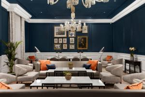 a lobby with blue walls and chairs and tables at Bristol Marriott Royal Hotel in Bristol