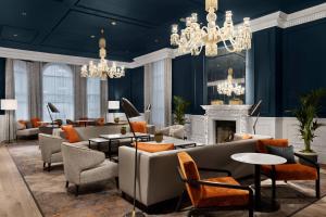 a lobby with couches and chairs and a fireplace at Bristol Marriott Royal Hotel in Bristol