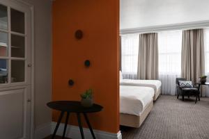 a hotel room with a bed and a table at Bristol Marriott Royal Hotel in Bristol