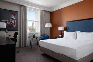 a hotel room with a large bed and a window at Bristol Marriott Royal Hotel in Bristol