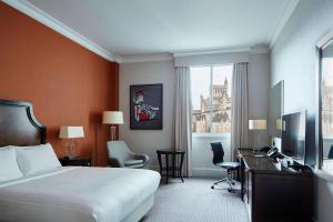 a hotel room with a bed and a desk and a computer at Bristol Marriott Royal Hotel in Bristol