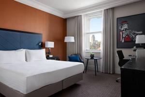 a hotel room with a large bed and a window at Bristol Marriott Royal Hotel in Bristol