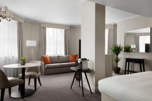 a hotel room with a couch and a table at Bristol Marriott Royal Hotel in Bristol