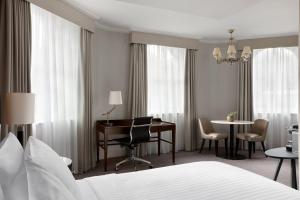 a hotel room with a bed and a desk and a table at Bristol Marriott Royal Hotel in Bristol