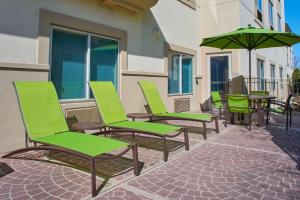 a row of chairs and an umbrella on a patio at Springhill Suites by Marriott Frankenmuth in Frankenmuth