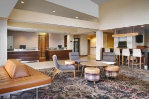 a hotel lobby with a couch and a table and chairs at Residence Inn by Marriott Greenville in Greenville