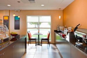 a kitchen with a counter and a table with chairs at Residence Inn Appleton in Appleton