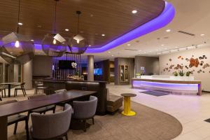 a lobby with a dining room with purple lighting at SpringHill Suites by Marriott Austin Cedar Park in Cedar Park
