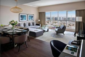 a living room with a couch and a table at Marriott Executive Apartments Downtown, Abu Dhabi in Abu Dhabi