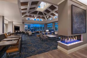 a lobby with a fireplace and tables and chairs at TownePlace Suites by Marriott San Diego Airport/Liberty Station in San Diego