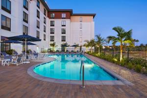 a pool with chairs and umbrellas in front of a hotel at TownePlace Suites by Marriott San Diego Airport/Liberty Station in San Diego