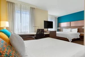 a hotel room with two beds and a television at Residence Inn by Marriott Secaucus Meadowlands in Secaucus