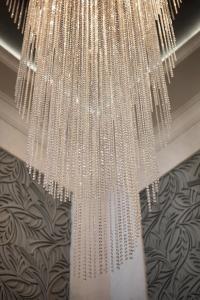 a chandelier full of beads hanging from a ceiling at Pik Palace, Shahdag, Autograph Collection in Shahdag