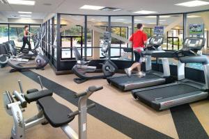 a man and a woman running on treadles in a gym at Atlanta Airport Marriott in Atlanta