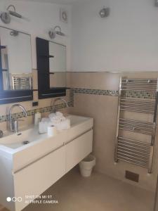 a bathroom with two sinks and a mirror at CA' VERDEMARE in Varazze