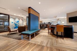 een lobby met een tafel en stoelen en een eetkamer bij TownePlace Suites by Marriott Monroe in Monroe