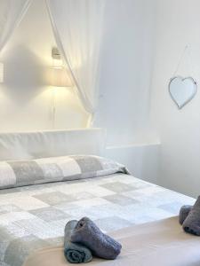 een slaapkamer met een bed met twee handdoeken erop bij Big Fish Alghero Guesthouse in Alghero
