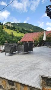 a group of benches sitting in front of a building at Pensiunea Paula in Moieciu de Sus