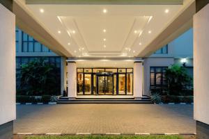 a lobby of a building with a large glass door at Protea Hotel by Marriott Benin City Select Emotan in Benin City
