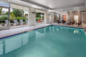 a swimming pool with blue water in a house at TownePlace Suites by Marriott Loveland Fort Collins in Loveland