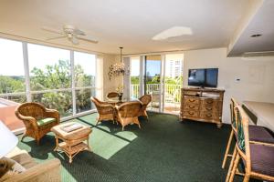 ein Wohnzimmer mit einem TV, einem Tisch und Stühlen in der Unterkunft Lovers Key Resort 308 in Fort Myers Beach