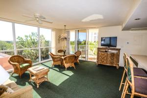 a living room with a television and a table and chairs at Lovers Key Resort 308 in Fort Myers Beach