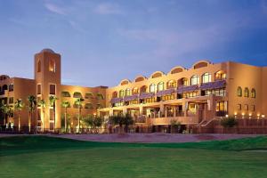 a large building with a clock tower at night at Scottsdale Marriott at McDowell Mountains in Scottsdale