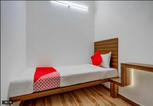 a bedroom with a bed with red pillows on it at SUKH PALACE in Shamsgarh