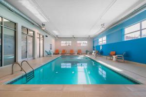 a large swimming pool with blue walls and a blue wall at Aloft Newport on the Levee in Newport